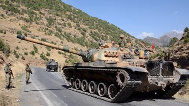 Turkish soldiers in a tank and an armored vehicle patrol on the road to the town of Beytussebab in the southeastern Sirnak province, Turkey. (File photo: Reuters)