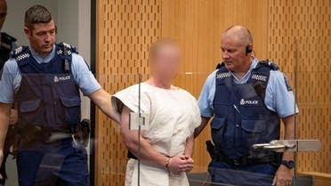 Brenton Tarrant, charged for murder in relation to the mosque attacks, is lead into the dock for his appearance in the Christchurch District Court. (Reuters)