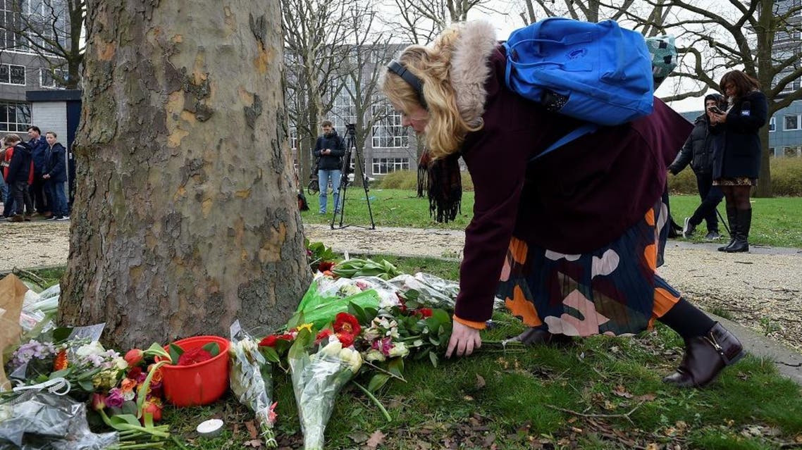 A women lay flowers at the site of a shooting in a tram, at 24 October square in Utrecht. (AFP)