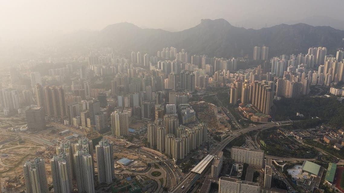 This aerial photo taken on November 23, 2018 shows residential estates in front of Lion Rock (top C) on a polluted day in Hong Kong. Dale DE LA REY / AFP