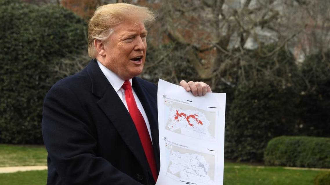 US President Donald Trump holds up a map as he speaks before departing the White House in Washington. (AFP)