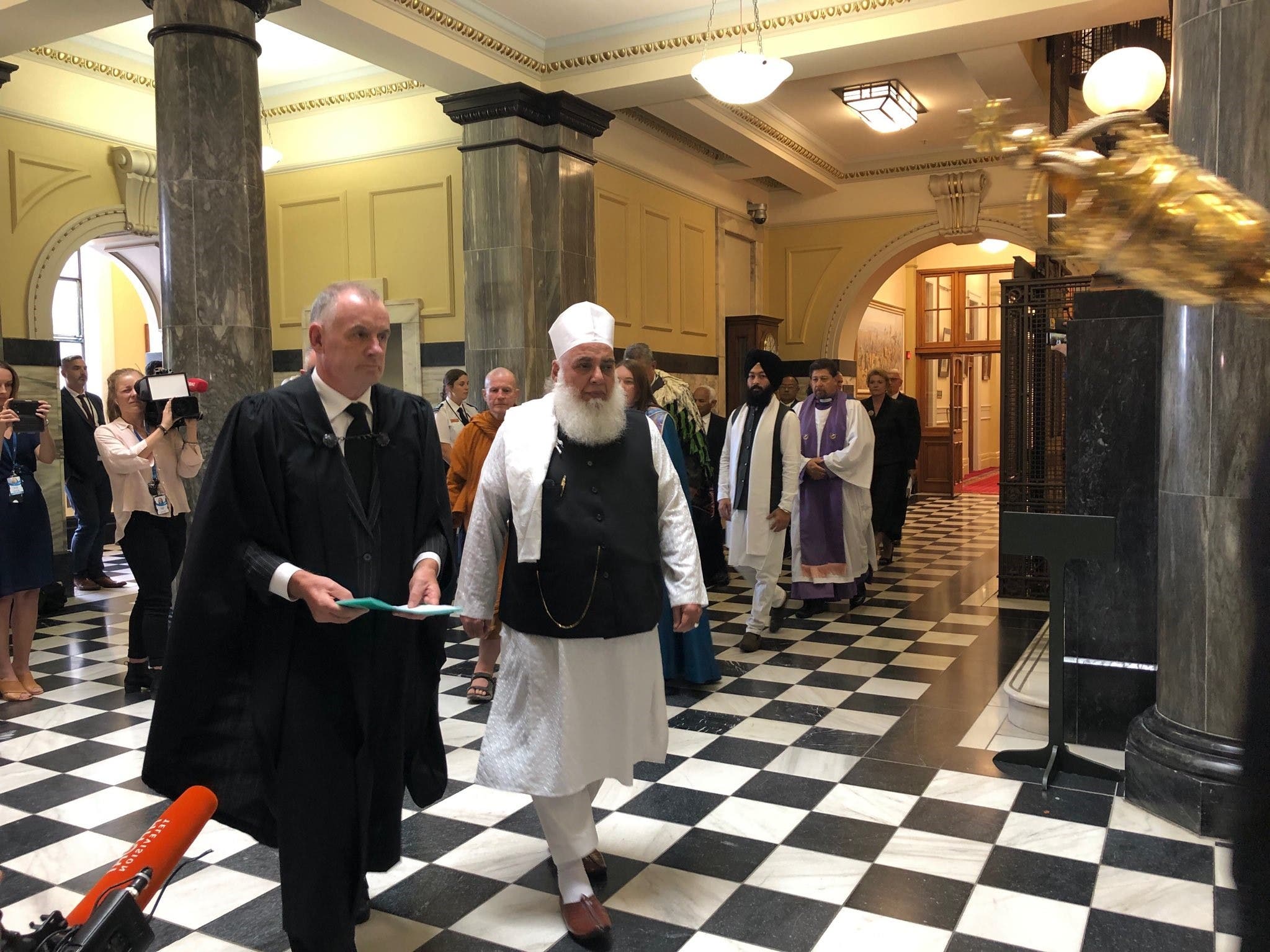 New Zealand Speaker of the House of Representatives Trevor Mallard walks with Imam Imam Nizam ul haq Thanvi