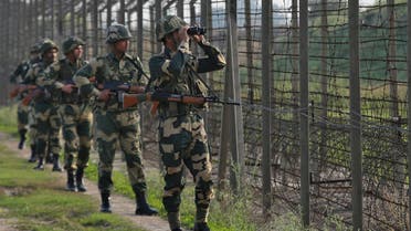 India’s Border Security Force soldiers patrol along the fenced border with Pakistan in the Ranbir Singh Pura sector near Jammu on February 26, 2019. (Reuters)