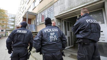 Police stand in front of a building in the northeastern German city of Schwerin (AP)
