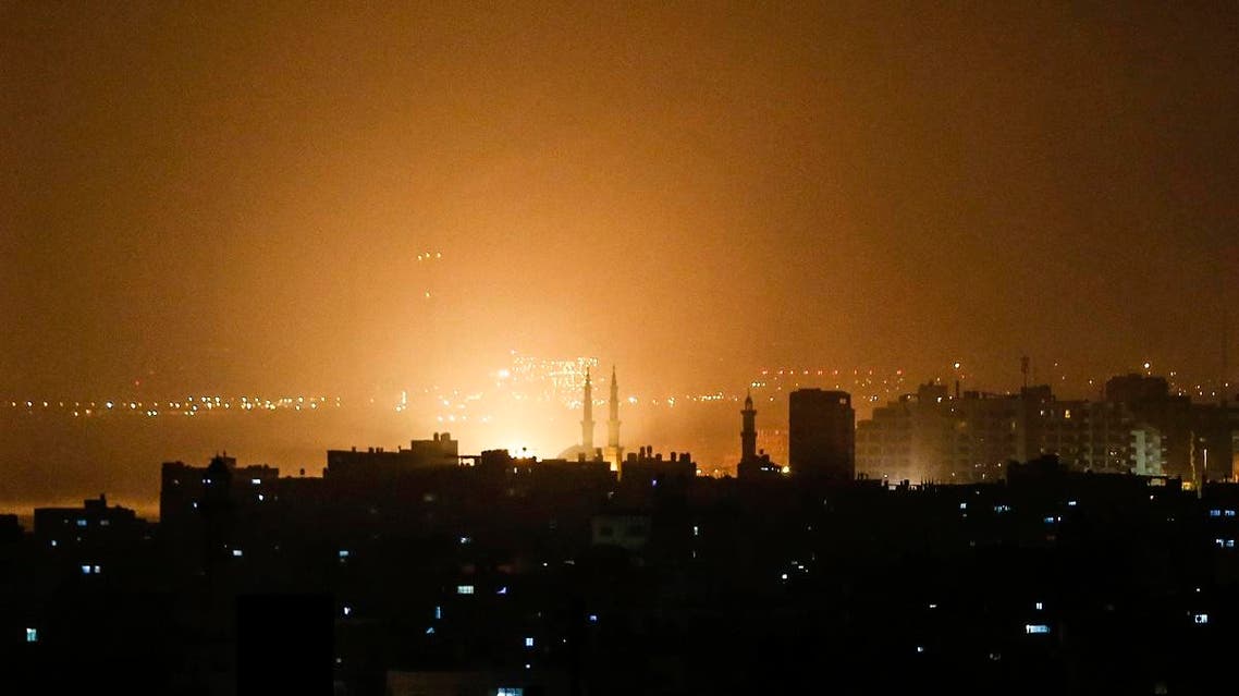 The sky above buildings on the Gaza Strip glows orange during an Israeli air strike in Gaza city on March 14, 2019.. (AFP)