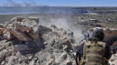 A fighter with the Syrian Democratic Forces (SDF) opens fire toward a part of Baghouz where remaining Islamic State (IS) group fighters are holding out in their last position, in the countryside of the eastern Syrian province of Deir Ezzor on March 18, 2019. (AFP)