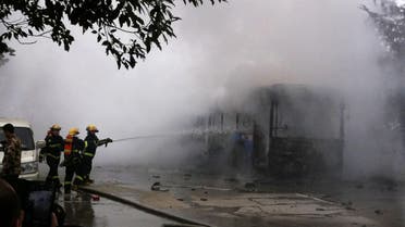 Chinese firefighters douse a public bus which caught fire, killing five people and injuring 32 in the southwestern Chinese city of Guizhou province on February 27, 2014. 