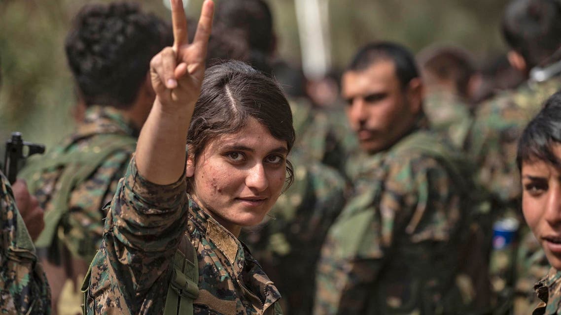 A female fighter of the Syrian Democratic Forces flashes the victory gesture while celebrating ISIS’s defeat in the eastern Syrian Deir Ezzor province on March 23, 2019. (AFP)