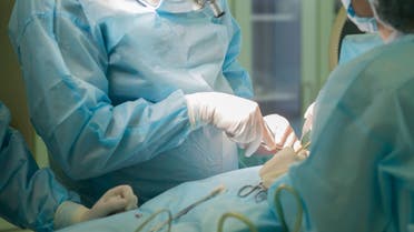 Surgeon at work. Surgery in hospital operating room - Stock image