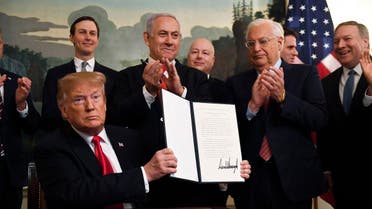 President Donald Trump holds up a signed proclamation recognizing Israel's sovereignty over the Golan Heights. (AP)