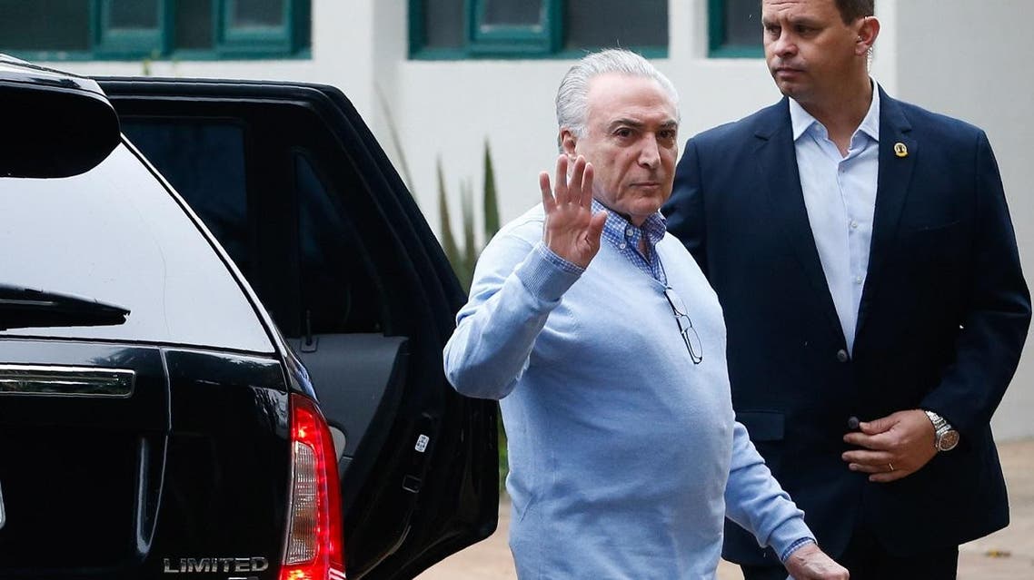 Brazil's ex-president Michel Temer waves upon arrival at a polling station. (AFP)