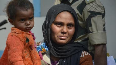 A Rohingya refugee weeps as she holds a child after they were detained while crossing the India-Bangladesh fenced border from Bangladesh, at Raimura village on the outskirts of Agartala, the capital of the northeastern state of Tripura, on January 22, 2019. Indian Border Security Force (BSF) officials said they had detained 31 Rohingya refugees crossing the border from Bangladesh. 