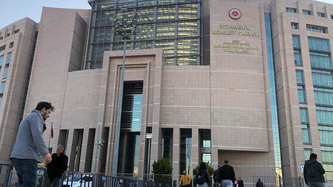 People walk to the Justice Palace as the trial against Metin Topuz begins. (AP)