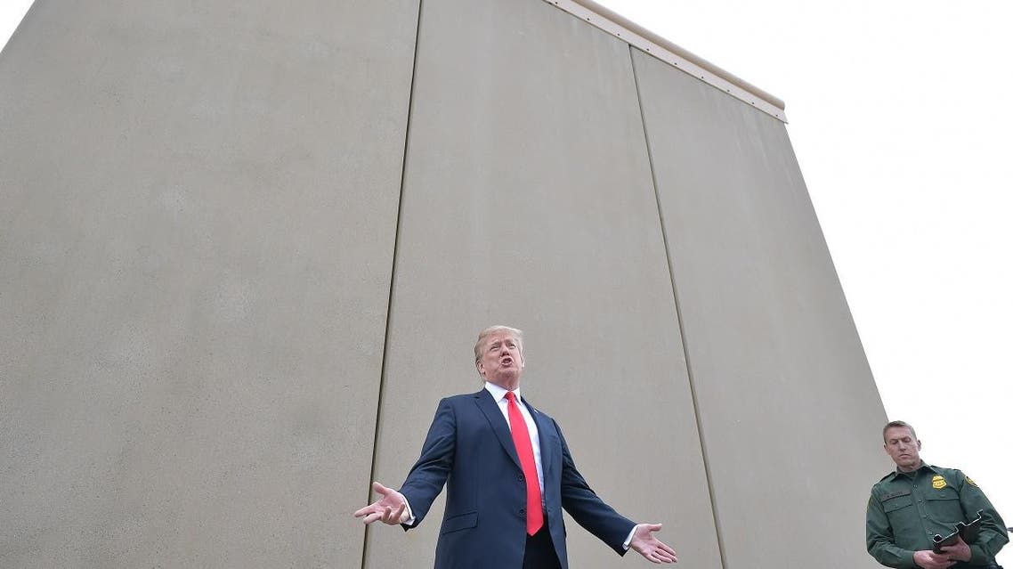 In this file photo taken on March 13, 2018 US President Donald Trump inspects border wall prototypes with Chief Patrol Agent Rodney S. Scott in San Diego, California. (AFP)