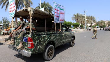 Houthi militants ride on the back of a police patrol truck as they secure a street where Houthi supporters demonstrated against British Foreign Secretary Jeremy Hunt in Hodeidah, Yemen March 5, 2019. The placards read: "Allah is the greatest .. death to America .. death to Israel .. a curse on Jews .. victory to Islam." and "Boycott the American and Israeli goods!". REUTERS/Abduljabbar Zeyad
