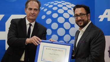 Pakistani freelance journalist Asad Hashim (R) receives the AFP AFP Asia Pacific Regional Director Philippe Massonnet during the award ceremony in Islamabad on March 26, 2019. (AFP)