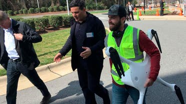 Matternet CEO Andreas Raptopoulos walks next to an operator carrying a drone used for delivery of medical specimens after a flight at WakeMed Hospital in Raleigh, North Carolina on March 26, 2019. (AP)
