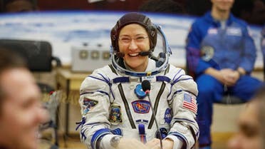 The International Space Station (ISS) crew member Christina Koch of the US smiles after donning a space suit shortly before launch at the Baikonur Cosmodrome. (Reuters)