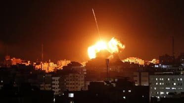 A ball of fire lights the sky above a building believed to house the offices of Hamas chief in Gaza, Ismail Haniyeh, during Israeli strikes on the Gaza City, on March 25, 2019. (AFP)