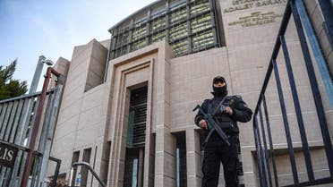 A Turkish policeman stands guard outside the courthouse in Istanbul on March 28, 2019, during the trial of Metin Topuz, an US consulate staffer accused of spying and attempting to overthrow the government. (AFP)