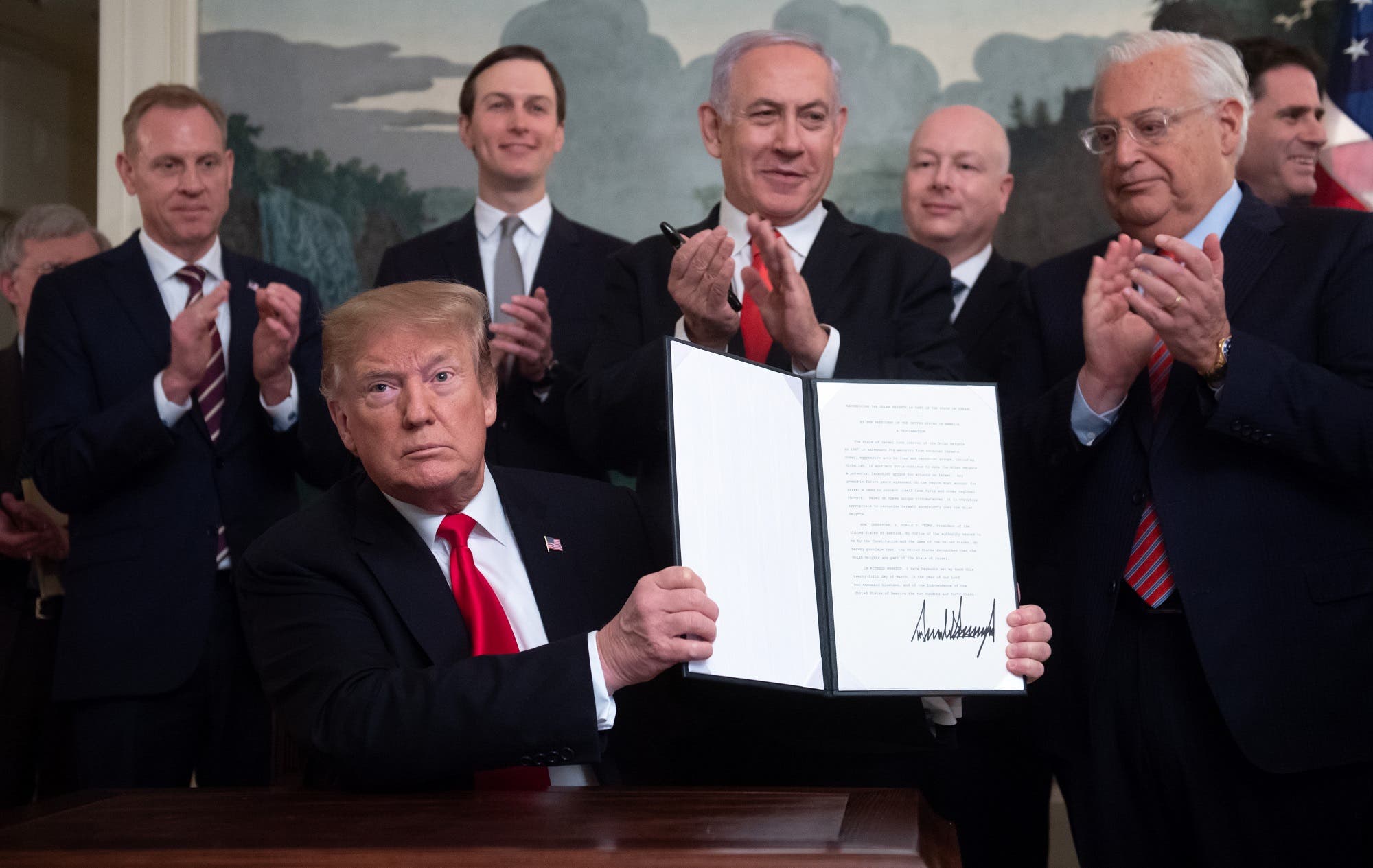 A file photo shows former president Trump holds up a signed Proclamation on the Golan Heights alongside Israeli PM Netanyahu in Washington, DC on March 25, 2019. (AFP)