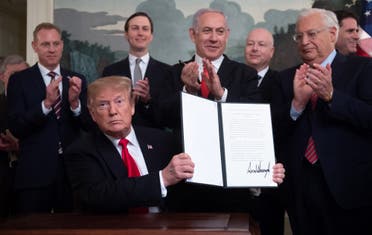 A file photo shows former president Trump holds up a signed Proclamation on the Golan Heights alongside Israeli PM Netanyahu in Washington, DC on March 25, 2019. (AFP)