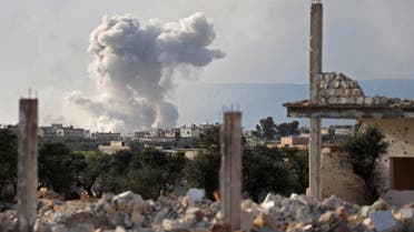 Smoke plume rising following a reported air strike in the north of Idlib province on March 22, 2019.