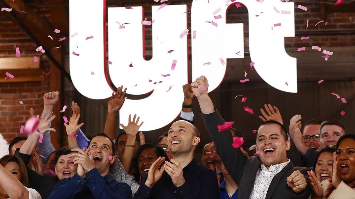 Confetti falls as Lyft CEO Logan Green (C) and President John Zimmer (Left C) ring the Nasdaq opening bell celebrating the company’s IPO on March 29, 2019 in Los Angeles, California. (AFP)