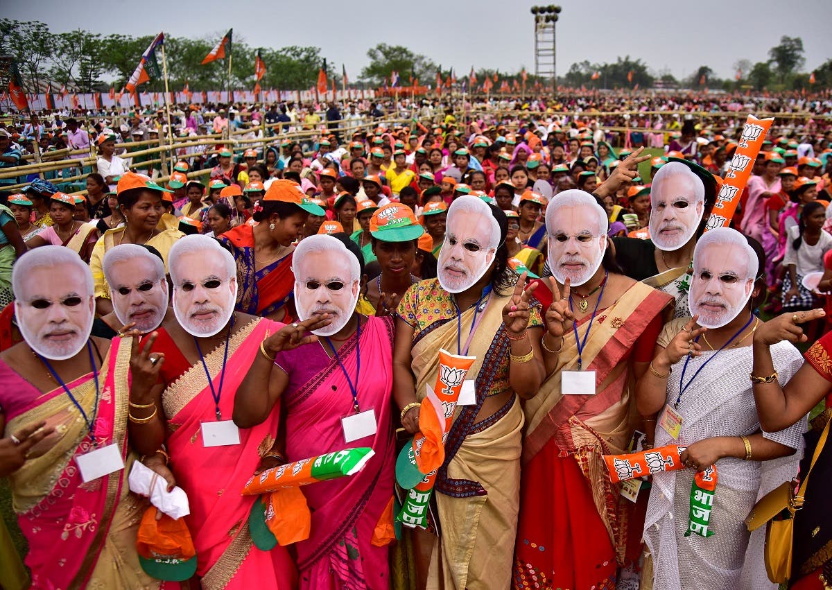 Supporters of India's ruling Bharatiya Janata Party wearing masks of Prime Minister Modi attend an election campaign rally addressed by Modi at Moran town in the northeastern state of Assam. (Reuters)