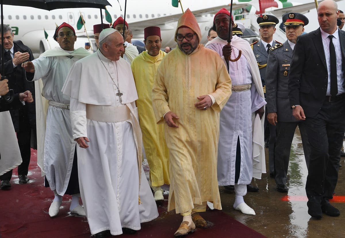 Pope Francis is received by Morocco's King Mohammed VI upon disembarking from his plane at Rabat-Sale International Airport near the capital Rabat. (AFP)