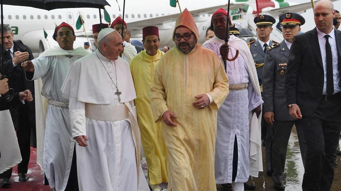 Pope Francis is received by Morocco's King Mohammed VI upon disembarking from his plane at Rabat-Sale International Airport near the capital Rabat. (AFP)