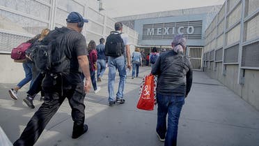 Pedestrians walk towards the US-Mexico border at the San Ysidro Port of Entry on March 29, 2019. (AFP)