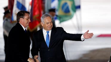 Israeli Prime Minister Benjamin Netanyahu gestures as he stands next to Brazilian President Jair Bolsonaro during a welcoming ceremony upon his arrival in Israel, at Ben Gurion International airport in Lod, near Tel Aviv, Israel. (Reuters)