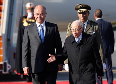 Tunisian President Beji Caid Essebsi (R) welcomes his Iraqi counterpart Barham Salih upon his arrival at Tunis-Carthage international airport on March 30, 2019, to attend the Arab Summit tomorrow. (AFP)