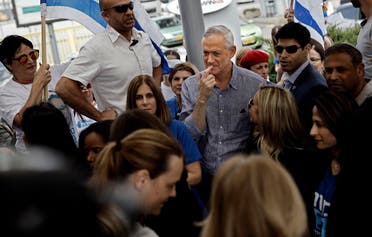 Retired Israeli general Benny Gantz (C), one of the leaders of the Blue and White (Kahol Lavan) political alliance, visits supporters in the Israeli city of Rehovot on April 5, 2019. (AFP)