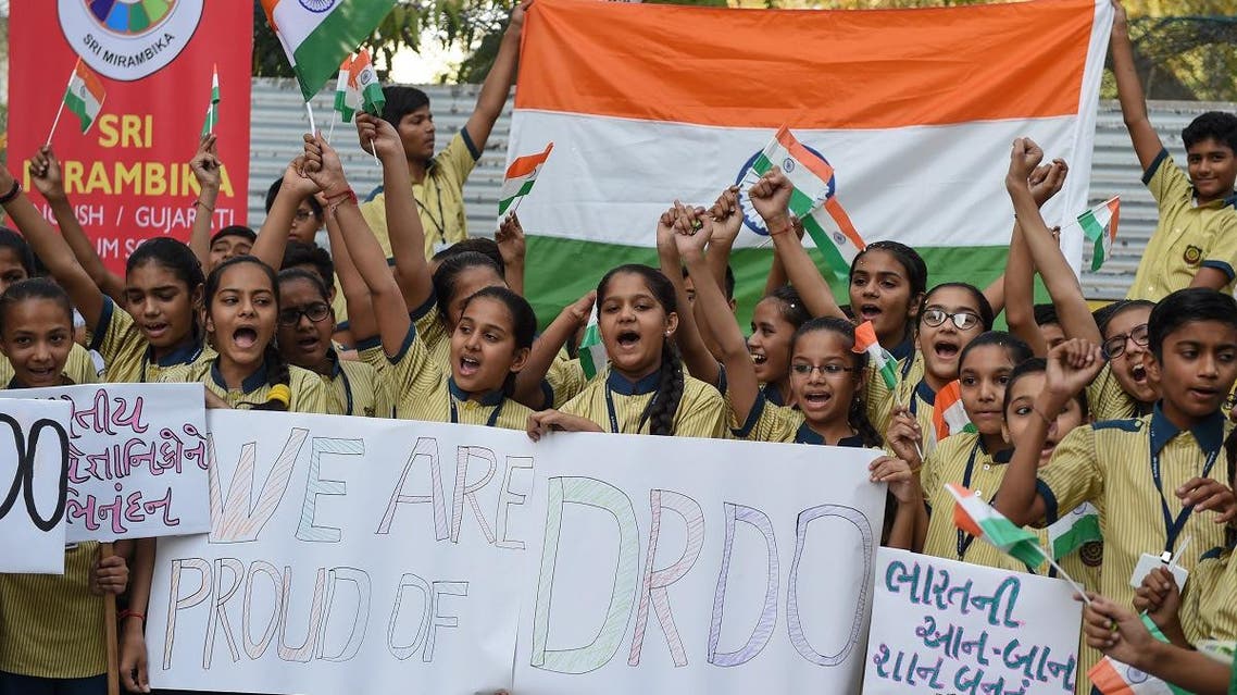Indian students celebrate after India shot down a low-orbiting satellite as part of a successful test of a new missile technology by the Defence Research and Development Organisation (DRDO), in Ahmedabad on March 27, 2019.