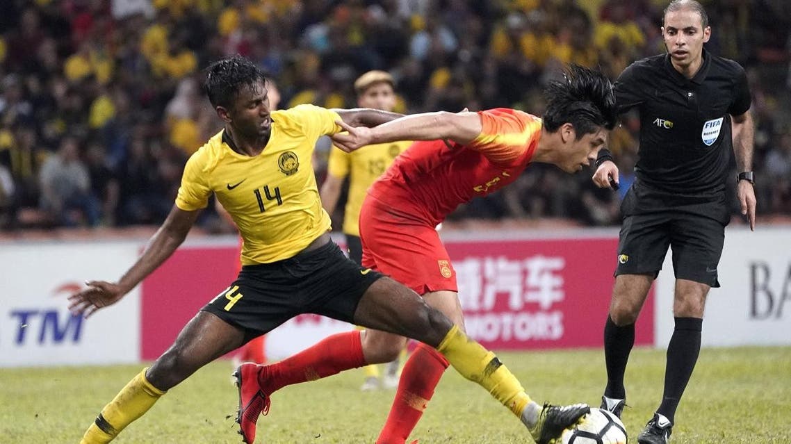 Malaysia’s Mohamed Syamer Kutty Abba (L) fights for the ball with China’s Zhang Yuning during the Tokyo 2020 Olympic Games men’s Asian qualifier football match between China and Malaysia in Shah Alam on March 26, 2019. (AFP)