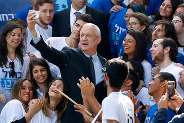 Retired Israeli general Benny Gantz, one of the leaders of the Blue and White (Kahol Lavan) political alliance, takes a picture with his supporters during a campaign event in the coastal city of Tel Aviv on April 8, 2019. (AFP)