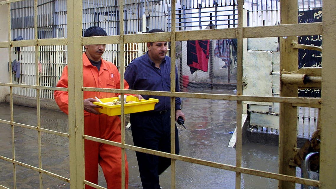 An Iraqi security man escorts a prisoner in a prison in Basra on 16 November 2005. (File photo: AFP)