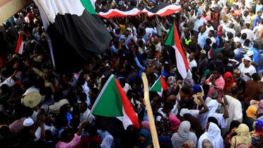 Sudanese demonstrators wave their national flag as they attend a protest rally demanding Sudanese President Omar Al-Bashir to step down outside the Defence Ministry in Khartoum, Sudan April 11, 2019.(Reuters)