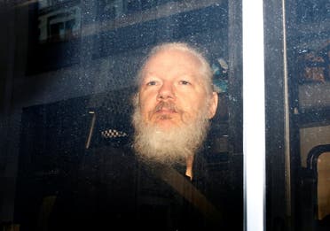 WikiLeaks founder Julian Assange is seen in a police van, after he was arrested by British police, in London. (Reuters)