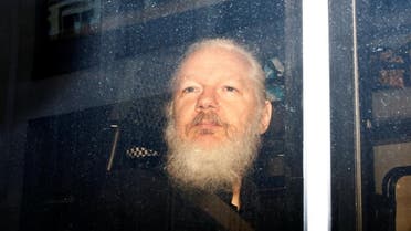 WikiLeaks founder Julian Assange is seen in a police van, after he was arrested by British police, in London. (Reuters)