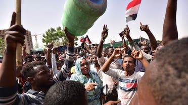 Sudanese demonstrators gather in a street in central Khartoum on April 11, 2019, after long-serving president Omar al-Bashir was ousted by the army. (AFP)