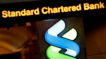 FILE PHOTO: FILE PHOTO: A logo of Standard Chartered is displayed at its main branch in Hong Kong, China August 1, 2017. REUTERS/Bobby Yip/File Photo