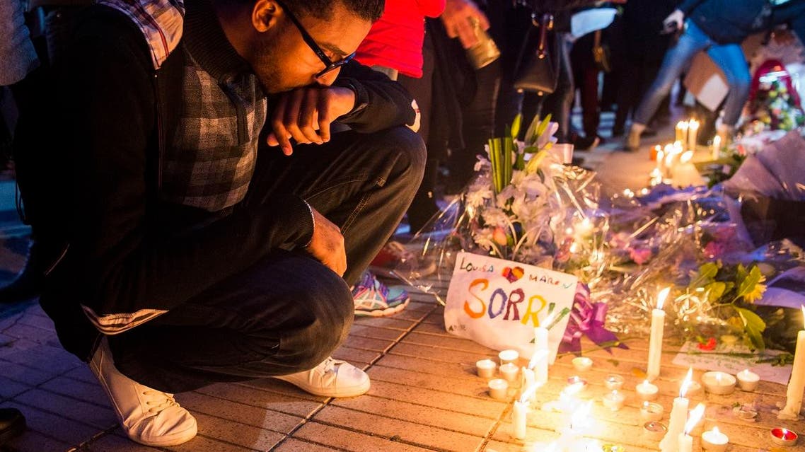 A Moroccan man places a candle during a vigil for the two Scandinavian hikers, who were killed in Morocco’s High Atlas mountains, outside the Danish Embassy in Rabat on December 22, 2018.(AFP)