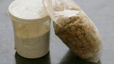 Captagon pills are displayed along with a cup of cocaine at an office of the Lebanese Internal Security Forces (ISF), Anti-Narcotics Division in Beirut on June 11, 2010. (AFP)