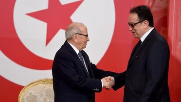 Tunisian President Beji Caid Essebsi (L) greets his son Hafedh Caid Essebsi, the general secretary of the Nidaa Tounes party. (AFP)