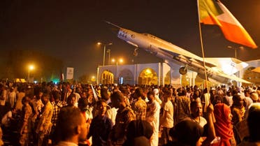 Sudanese demonstrators celebrate after the Defence Minister Awad Ibn Auf stepped down as head of the country's transitional ruling military council, as protesters demanded quicker political change, outside the Defence Ministry in Khartoum. (Reuters)