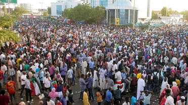Sudanese demonstrators gather to celebrate after Defence Minister Awad Ibn Auf stepped down as head of the country's transitional ruling military council. (Reuters)