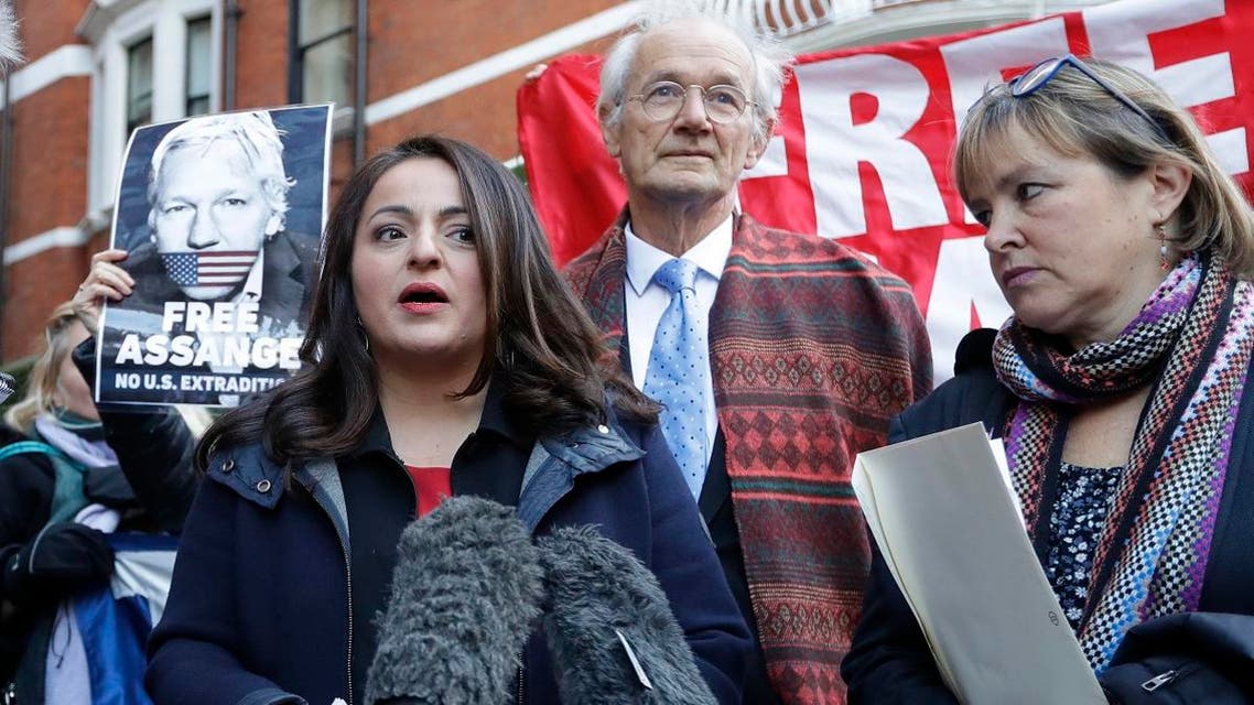 German MP Sevim Dagdelen, left, speaks to the media alongside John Shipton, biological father of Julian Assange, and German MP Heike Hansel, right, outside the Ecuadorian embassy in London, Thursday, Dec. 20, 2018. (AP)
